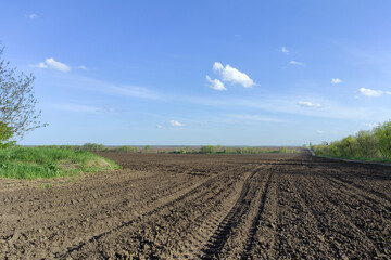 Plowed agricultural field with traces of the agricultural machinery