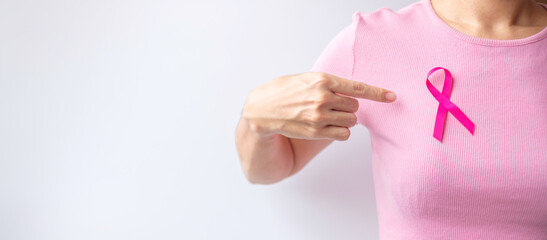 Pink October Breast Cancer Awareness month, woman hand hold pink Ribbon and wear shirt for support people life and illness. National cancer survivors month, Mother and World cancer day concept