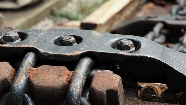Bolt clutch of chain traction engineering industrial mechanism with rust closeup