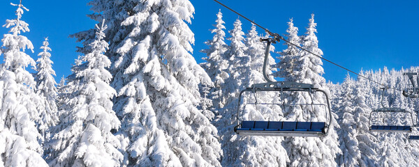 Ski resort, ski lift and snow pine trees