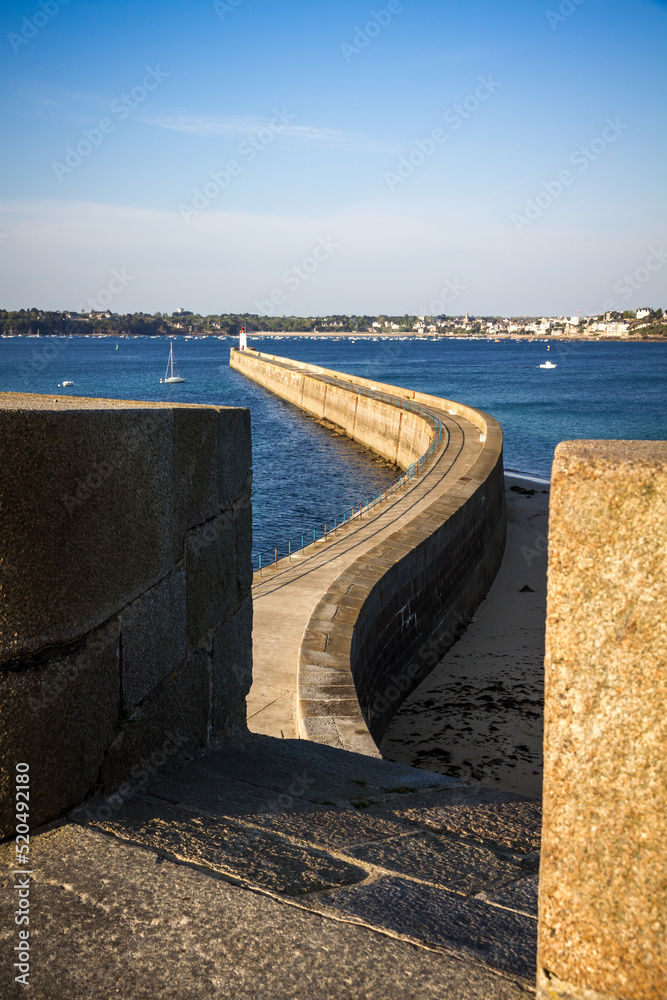 Wall mural Saint-Malo lighthouse and pier view from the city fortifications, Brittany, France