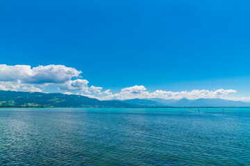 Germany, Beautiful panorama view above lakeside of turquoise bodensee lake water at austrian coast...