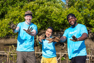 Team of young and diversity volunteer worker group enjoy charitable social work outdoor in mangrove planting NGO work for fighting climate change and global warming in coastline habitat project