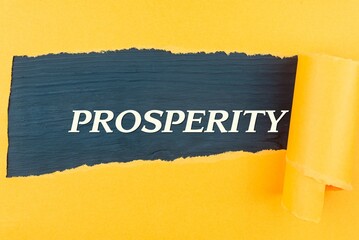 PROSPERITY - text appearing behind torn yellow paper. Business concept: buying, selling, commerce (copy space).