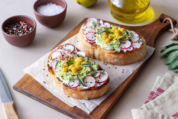 Bruschetta with guacamole, radish, white cheese, chickpeas and sage. Vegetarian food. Sandwich. Italian food.