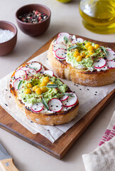 Bruschetta with guacamole, radish, white cheese, chickpeas and sage. Vegetarian food. Sandwich. Italian food.