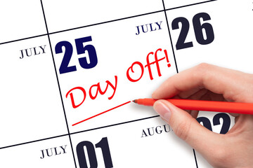 25th day of July. Hand writing text DAY OFF and drawing a line on calendar date 25 July. Vacation...