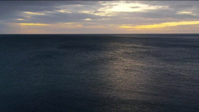 An aerial view of an terribly beautiful ocean at sunset time yellow sky in the background in Thailand