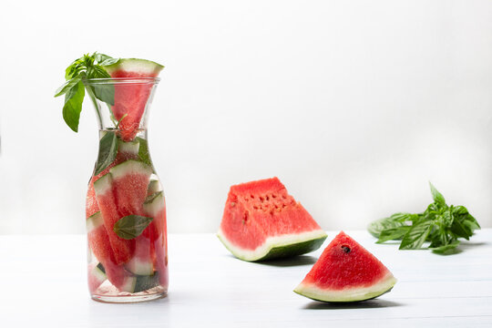 Sparkling watermelon water with basil in glass jar.