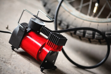 A motorbike wheel and tyre inflator close up.