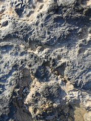 Coast of the Mediterranean Sea, long frozen lava. Background. It looks like an alien landscape.