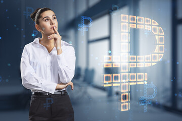 Attractive thoughtful young european businesswoman with creative glowing Russian ruble hologram on blurry office interior background. Digital money and online banking concept. Double exposure.