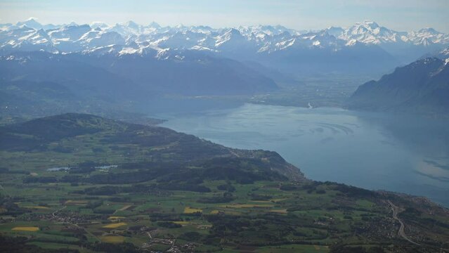Swiss countryside and part of the Geneva (Leman) lake with the Alps in the background, aerial view