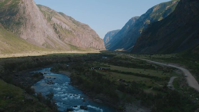 Valley Chulyshman with river and mountains with blue clear sky in Altai, Siberia, Russia. Beautiful summer nature landscape at during daytime. Aerial view from a drone