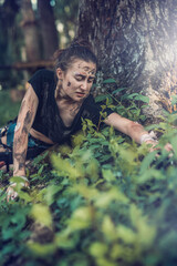 Young woman holding sharp bayonet knife in forest