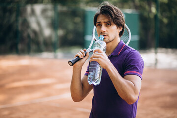 Young man tennis player at the court