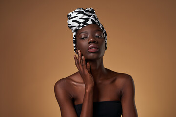Thoughtful young black girl wearing african turban