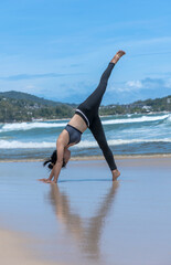Strong sport woman wearing sportswear doing exercise on beach, Yoga concept