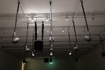 Young man listening to sound music surround installation with many speakers above