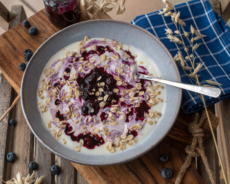 Breakfast yogurt with blueberry compote and oat flakes