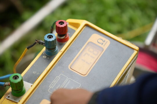 Technician using the old equipment and Earth resistance tester.