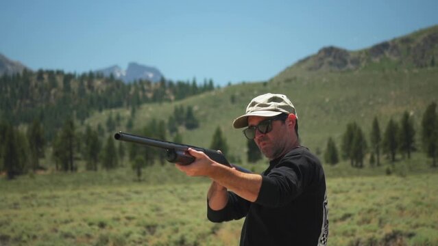 A male gunman shooting multiple shots with a pump action shotgun, Mammoth Lakes