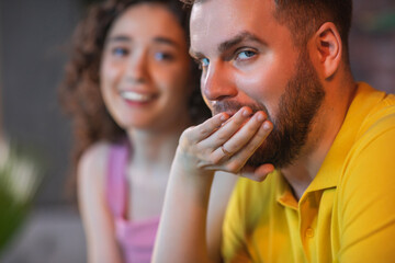 Pretty couple watching together in the evening on sport channel their favourite sport match they getting excited when favourite team getting the victory