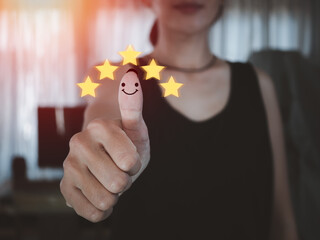 woman thumbs up with smiling face To give a 5-star satisfaction rating, customers give a very good service satisfaction rating of 5 stars.