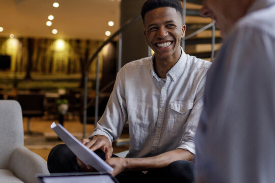 Multiracial male professionals analyzing plans in office