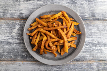 Heap of fried potato on a gray plate. Top view, close up.