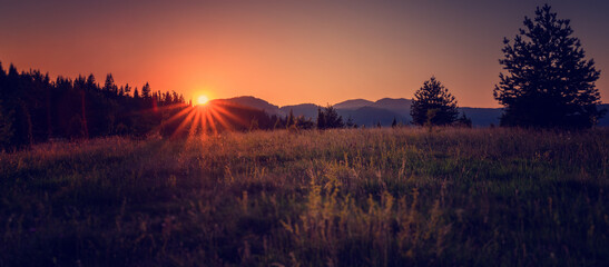 Sunset in the mountains on a meadow, beautiful landscape