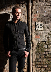 Urban attitude: a dark look. A confident stance from an alternative lifestyle character; from a...