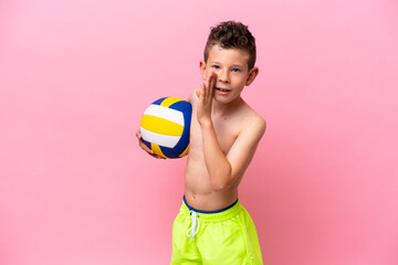 Little caucasian boy playing volleyball isolated on pink background whispering something