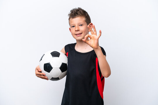 Little caucasian boy isolated on white background with soccer ball and making OK sign