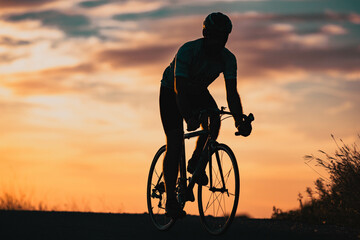 cyclist silhouette at sunset sports and fitness concept
