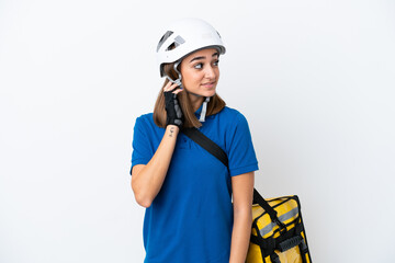 Young caucasian woman with thermal backpack isolated on white background thinking an idea