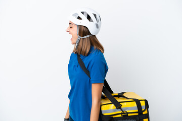 Young caucasian woman with thermal backpack isolated on white background laughing in lateral position