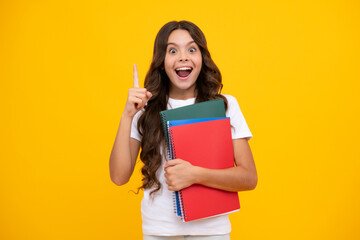 Amazed teen girl. Teenager school girl with books isolated studio background. Excited expression, cheerful and glad.