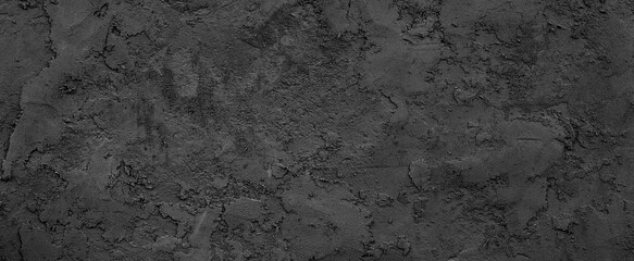 Fototapeta na wymiar Black or dark gray rough grainy soil-like texture background