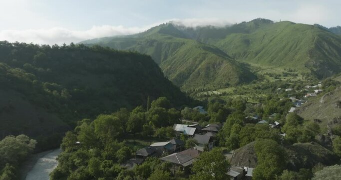 Tranquil Small Town In Towering Lush Forest Mountains In Daba, Region Of Samtskhe-Javakheti, Georgia. Aerial Wide Shot