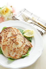 Asian food, butter pan fried swordfish fillet served lemon on lettuce