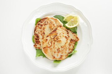 Asian food, butter pan fried swordfish fillet served lemon on lettuce