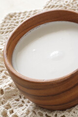 coconut milk in wooden bowl with copy space 