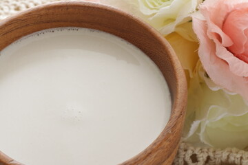 coconut milk in wooden bowl with copy space 