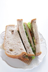 Homemade swordfish fillet and lettuce sandwiches on dish with copy space