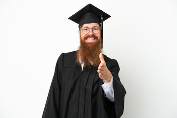 Young university graduate reddish man isolated on white background shaking hands for closing a good deal