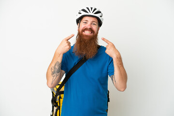 Young reddish caucasian man with thermal backpack isolate don white background giving a thumbs up gesture