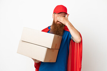 Super Hero delivery reddish man isolated on white background covering eyes by hands. Do not want to see something