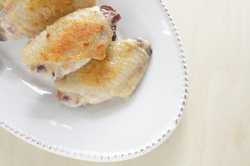 Chinese food, pan fried chicken wings on plate 