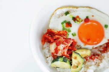 Korean food, deep fried zucchini and Kimchi with sunny side up fried egg on rice